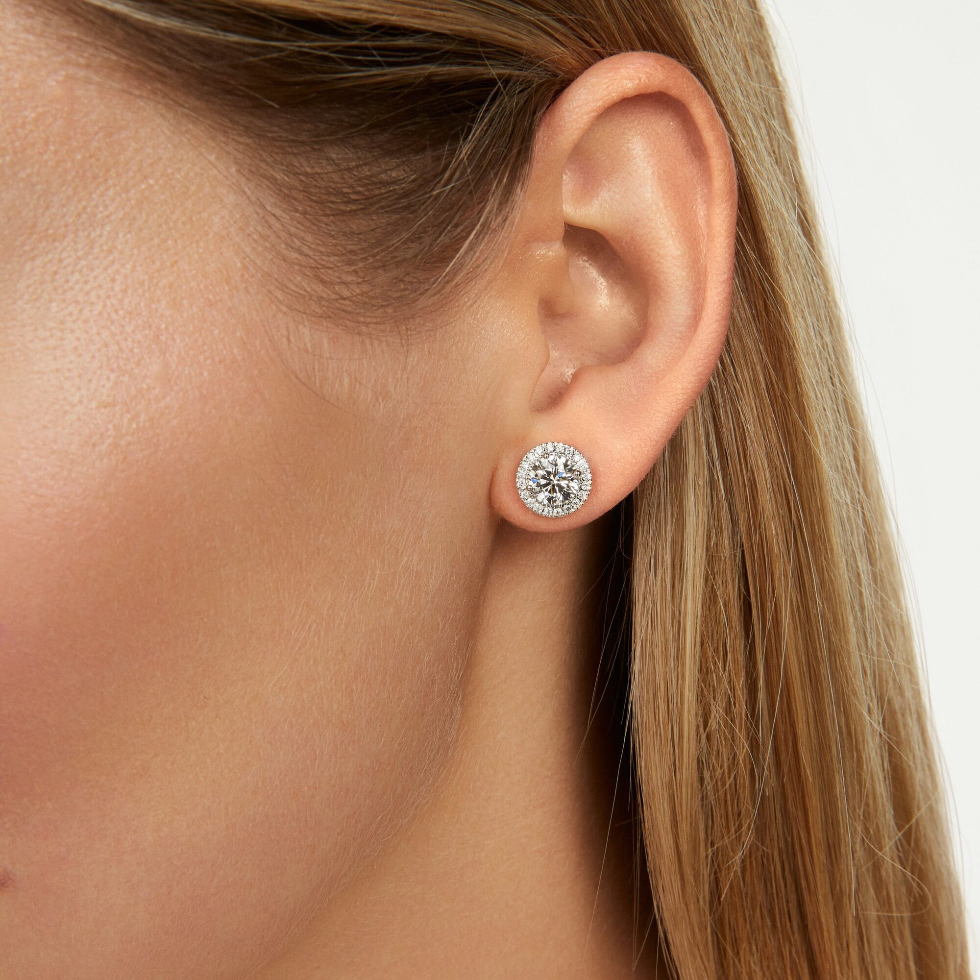ER108670_White-2ct-halo-studs_close-up_Fair-Skin.jpg